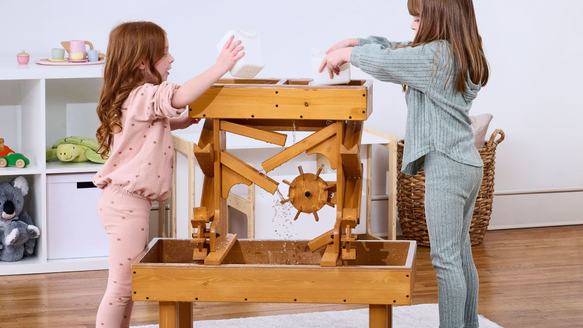 Toddler playing at an Avenlur outdoor wooden water table