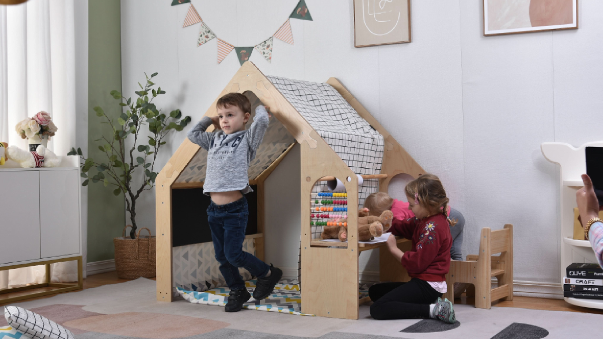 Child playing in an Avenlur Flair wooden indoor playhouse