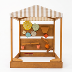 Wooden toy with colorful gears and a striped canopy on a white background