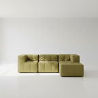 Green sectional sofa on a white floor with a white wall background