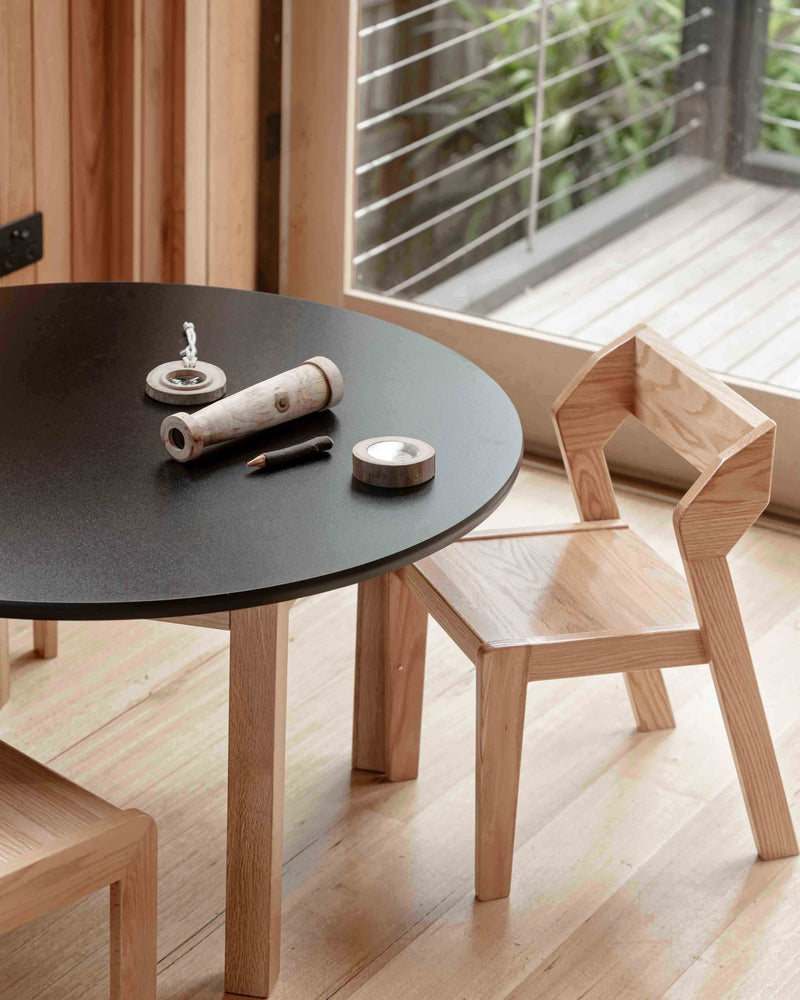 Close-up of Alfie stacking chair showing geometric backrest and contoured seat