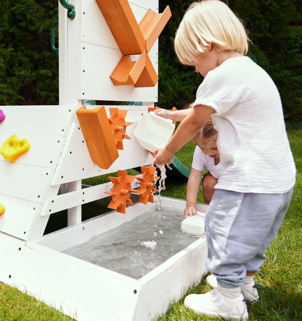 Kids playing with the Avenlur Aloe outdoor playhouse water activity station and splash basin