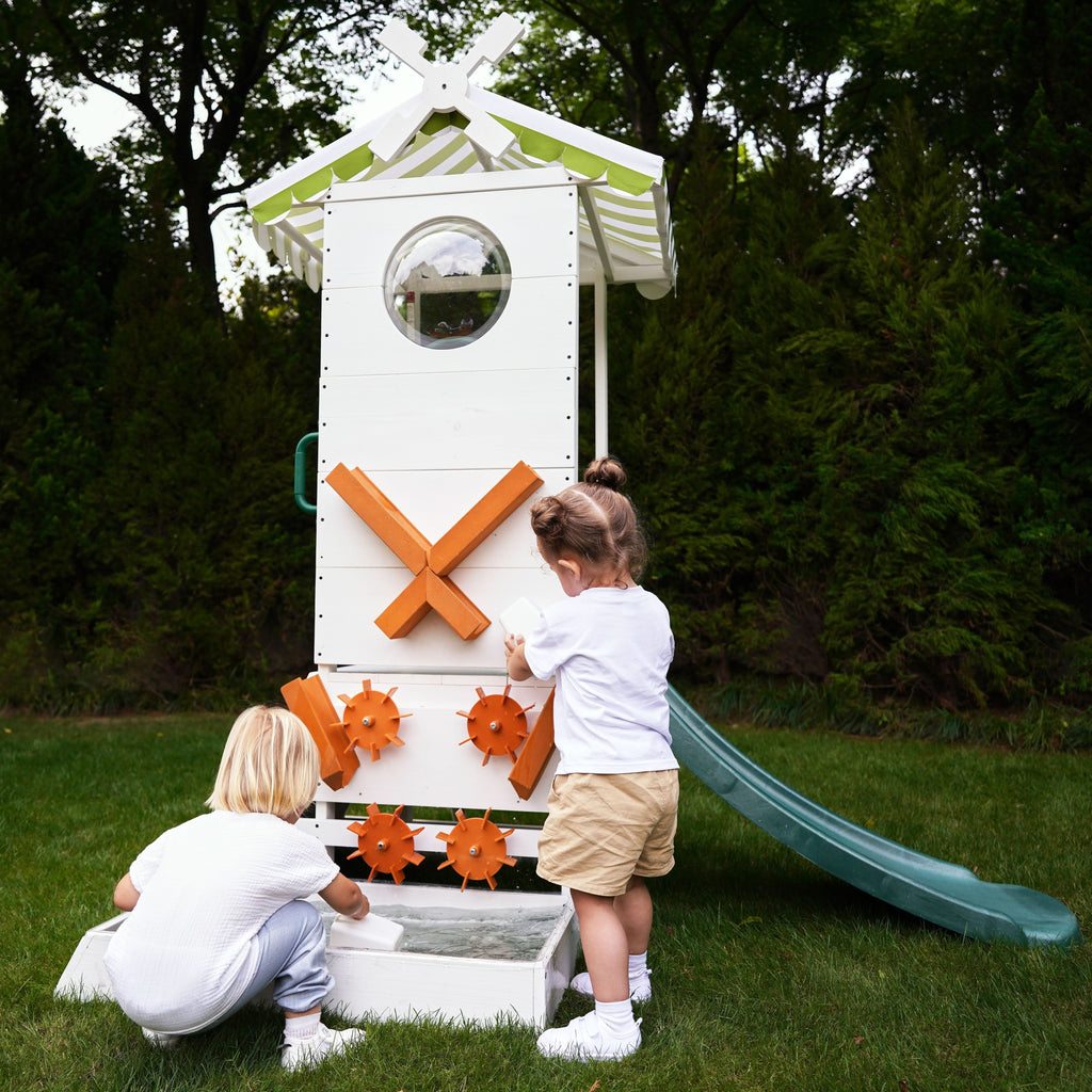 Children pouring water into the Aloe playhouse sensory play basin and wheel system