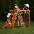 Toddler going down the Avenlur Chestnut slide outdoors