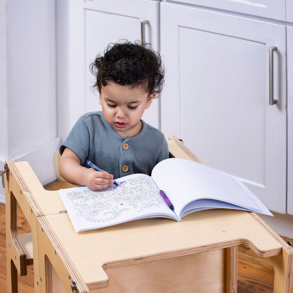 Child using the Avenlur Date kitchen helper tower to wash vegetables