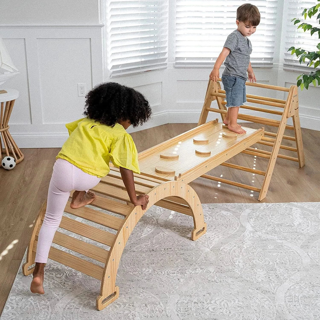Two toddlers climbing on Avenlur Hazel Pikler Triangle with rocker and slide in a bright Montessori playroom