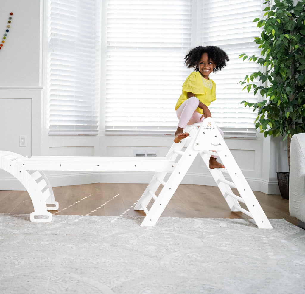 Toddler balancing on the Avenlur Hazel rocker