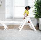 Toddler balancing on the Avenlur Hazel rocker