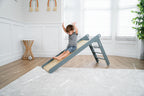 Avenlur Holland wooden folding slide for toddlers next to a ball pit