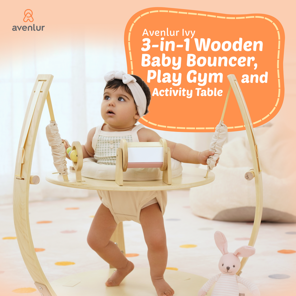 Baby in the Avenlur Ivy 3-in-1 baby bouncer, play gym and activity table