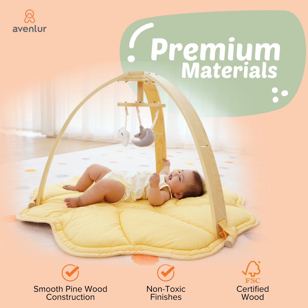 Baby on a play mat under the Avenlur Ivy play gym