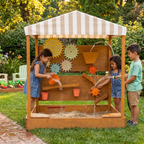 Children playing with the Avenlur Koa water wall in the backyard