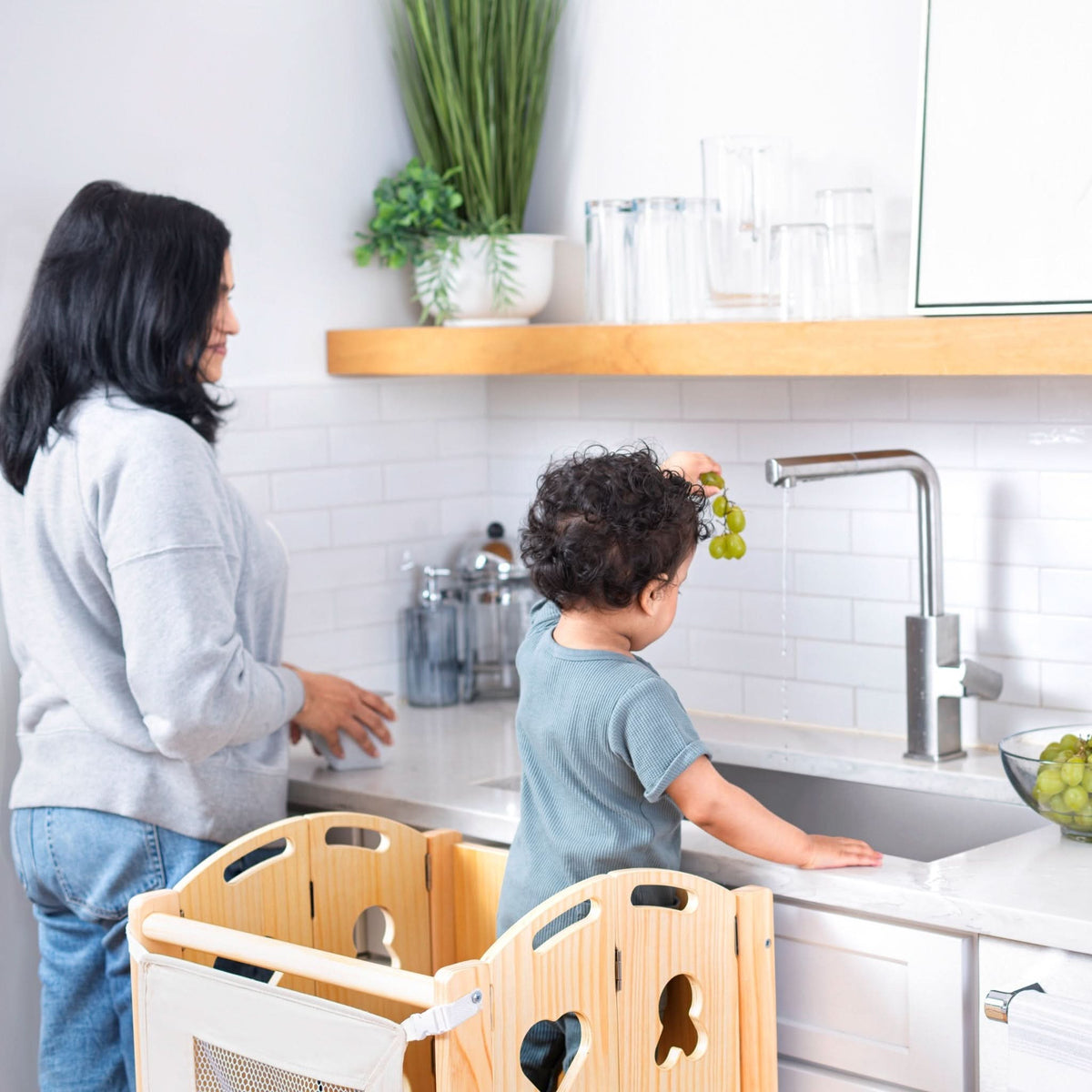 Avenlur Laurel foldable toddler tower at the kitchen counter