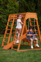 Child going down the slide of the Avenlur Magnolia outdoor climbing structure