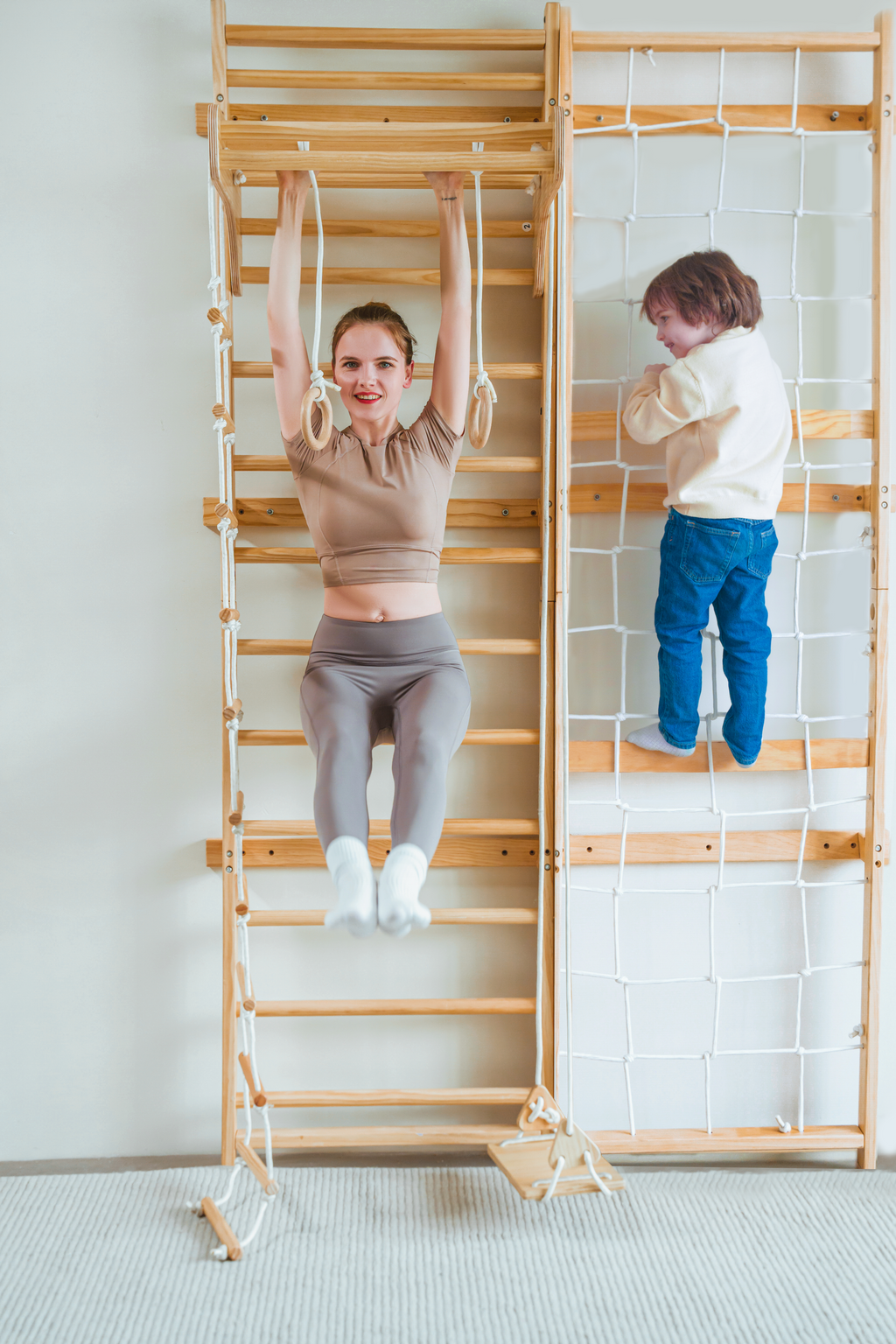 Avenlur Neem rope climbing wall for kids next to a wooden wall ladder