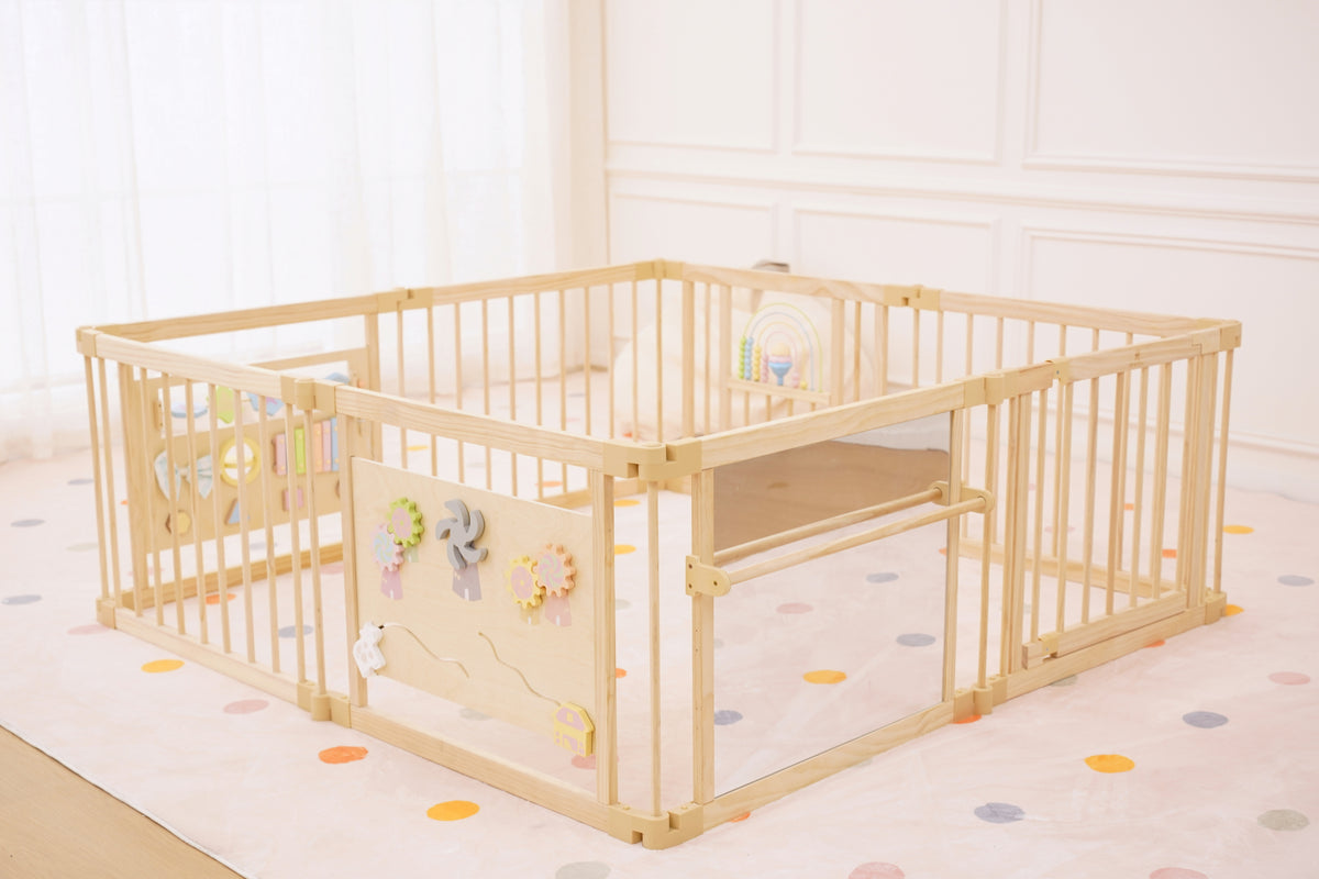 Baby pulling up on the Avenlur playpen safety mirror bar