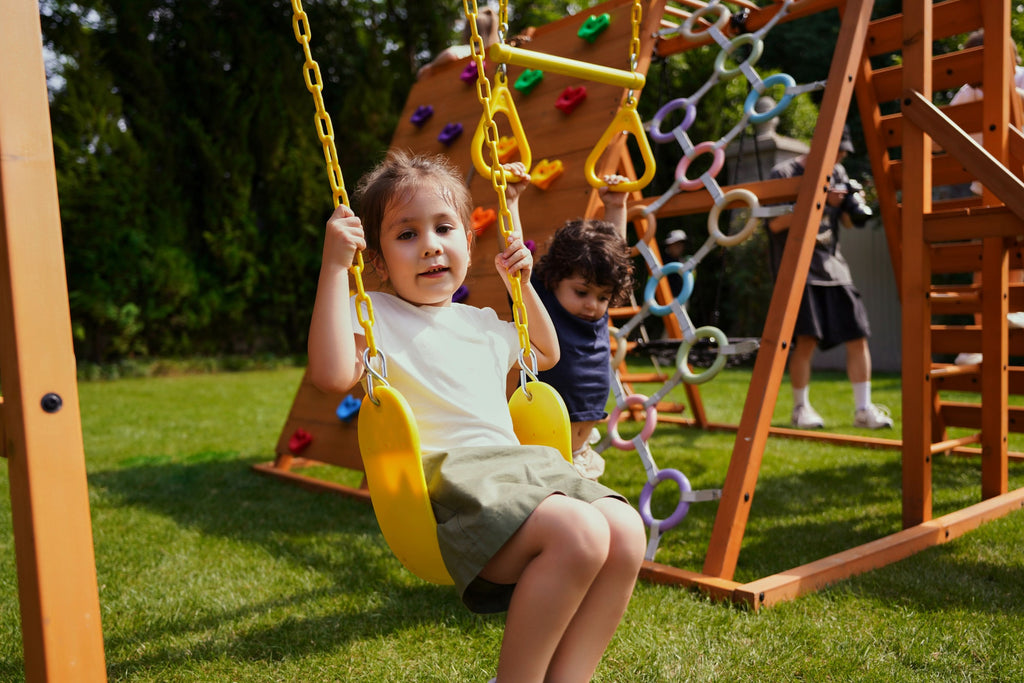 Avenlur Sycamore Jumbo kids outdoor climbing structure with trapeze bar and swings