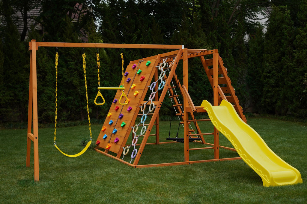 Side view of the Avenlur Sycamore Jumbo wooden swing set and climbing jungle gym in a backyard