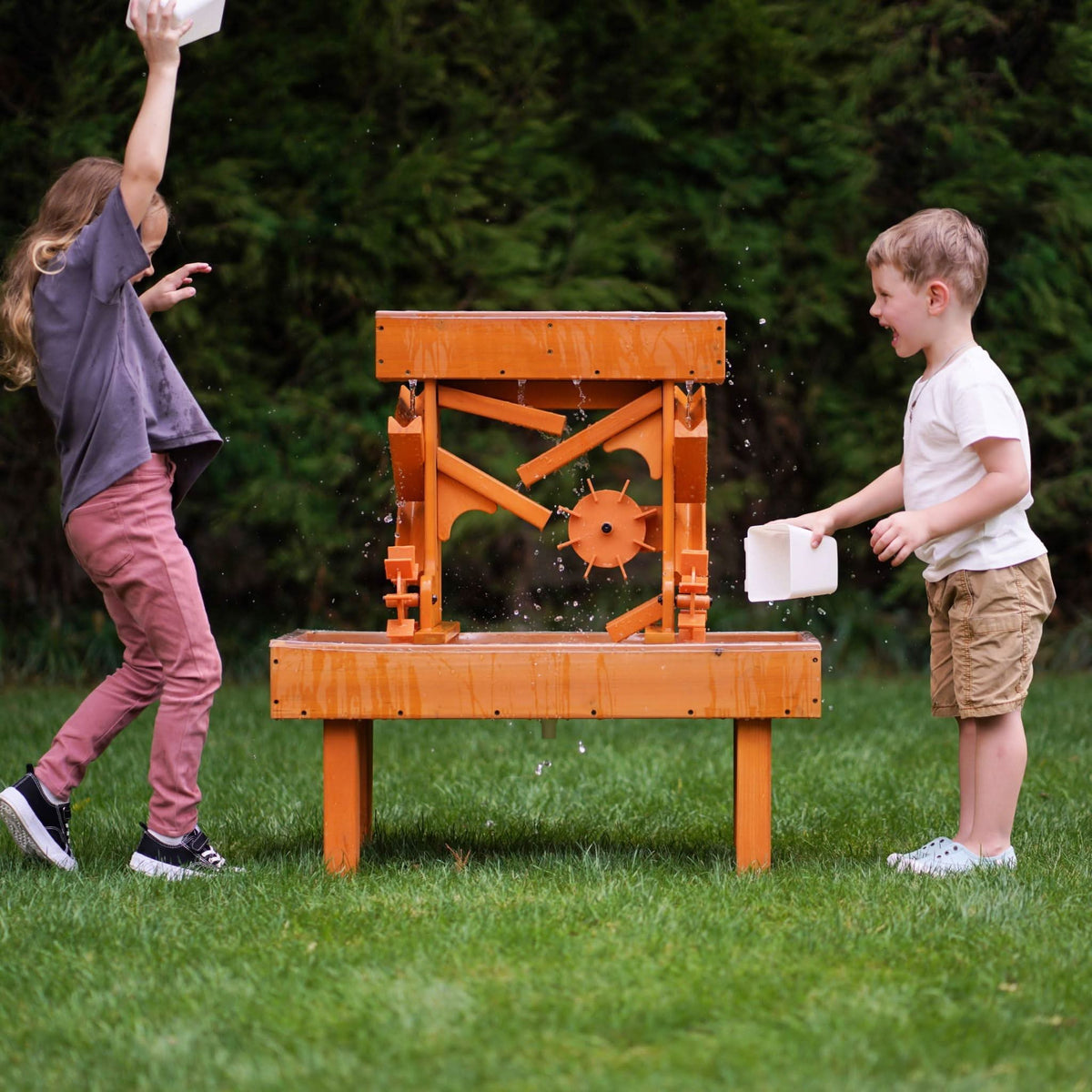 Toddler splashing at the Avenlur outdoor water table