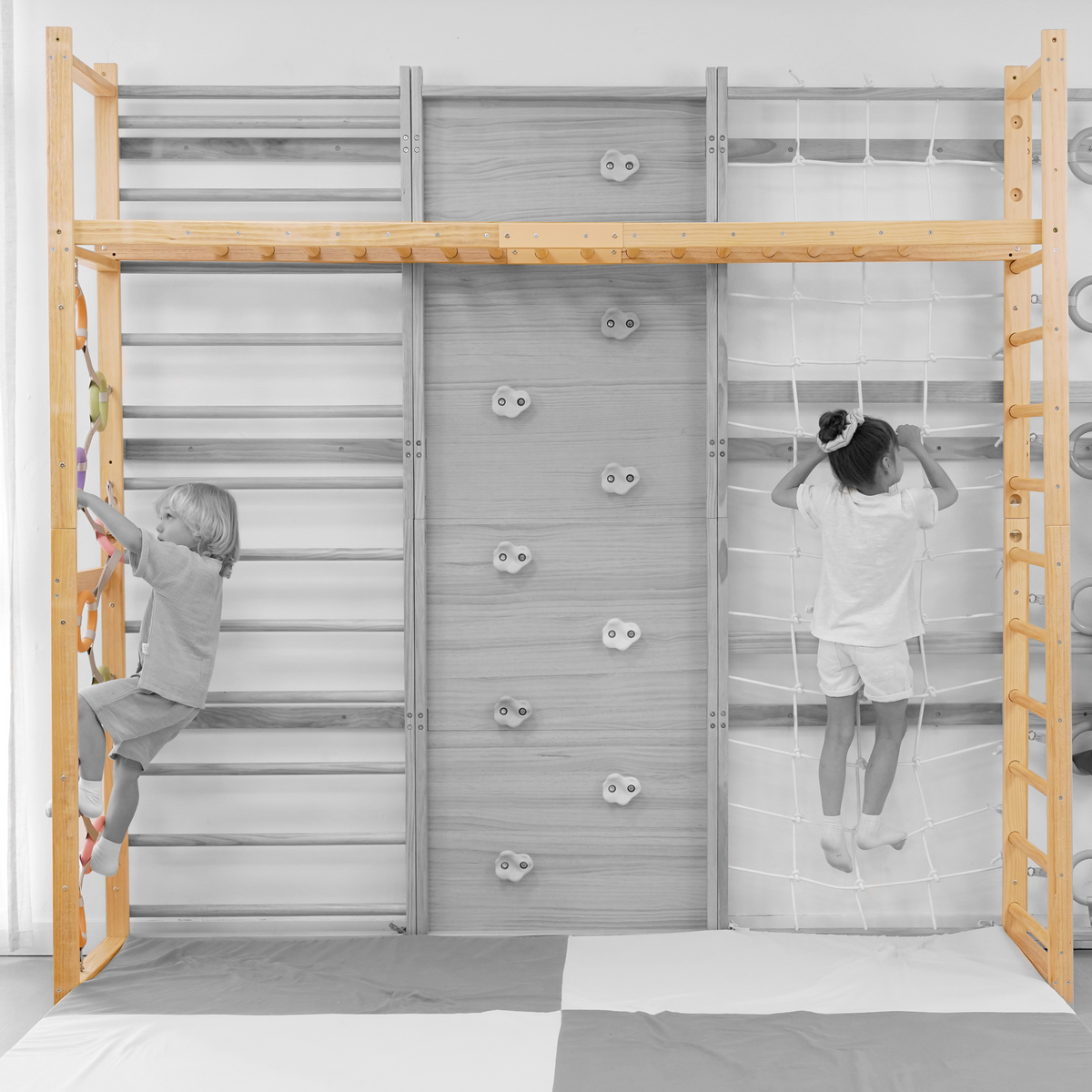 Kids using the Avenlur indoor monkey bars on the 95 inch Walnut Swedish ladder