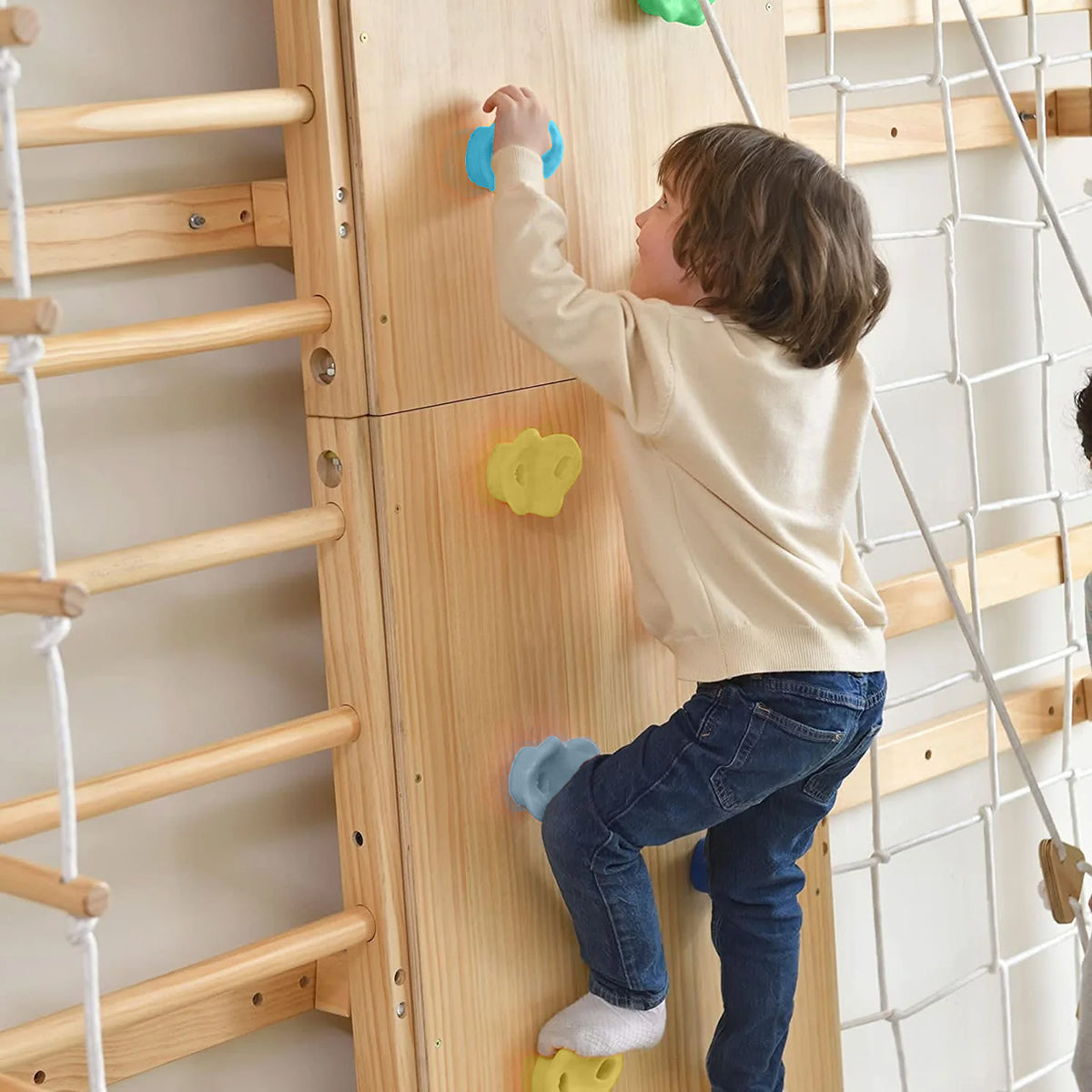 Child climbing the Avenlur Walnut Swedish wall ladder