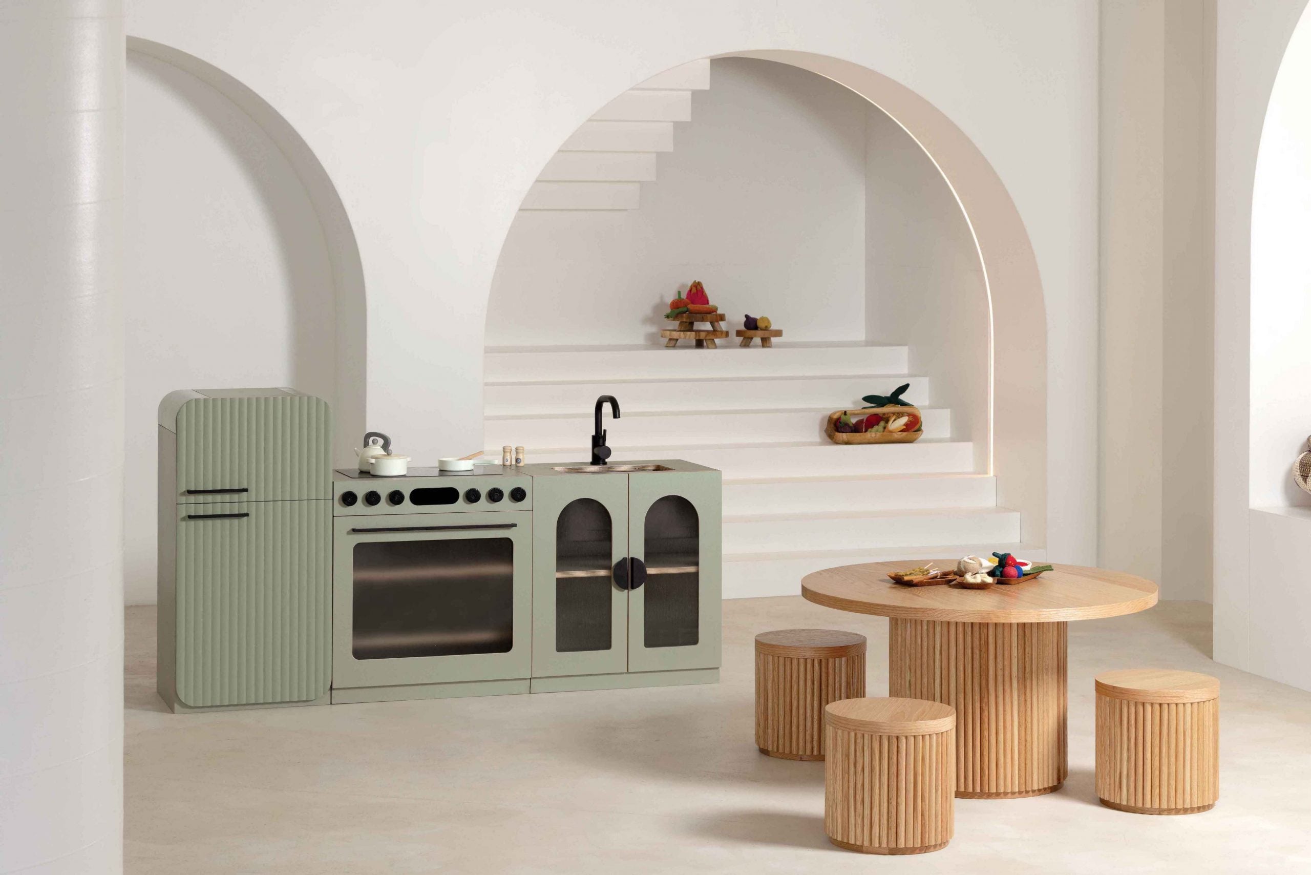 Sage Fluted play oven beside the matching fridge and sink in a studio setting