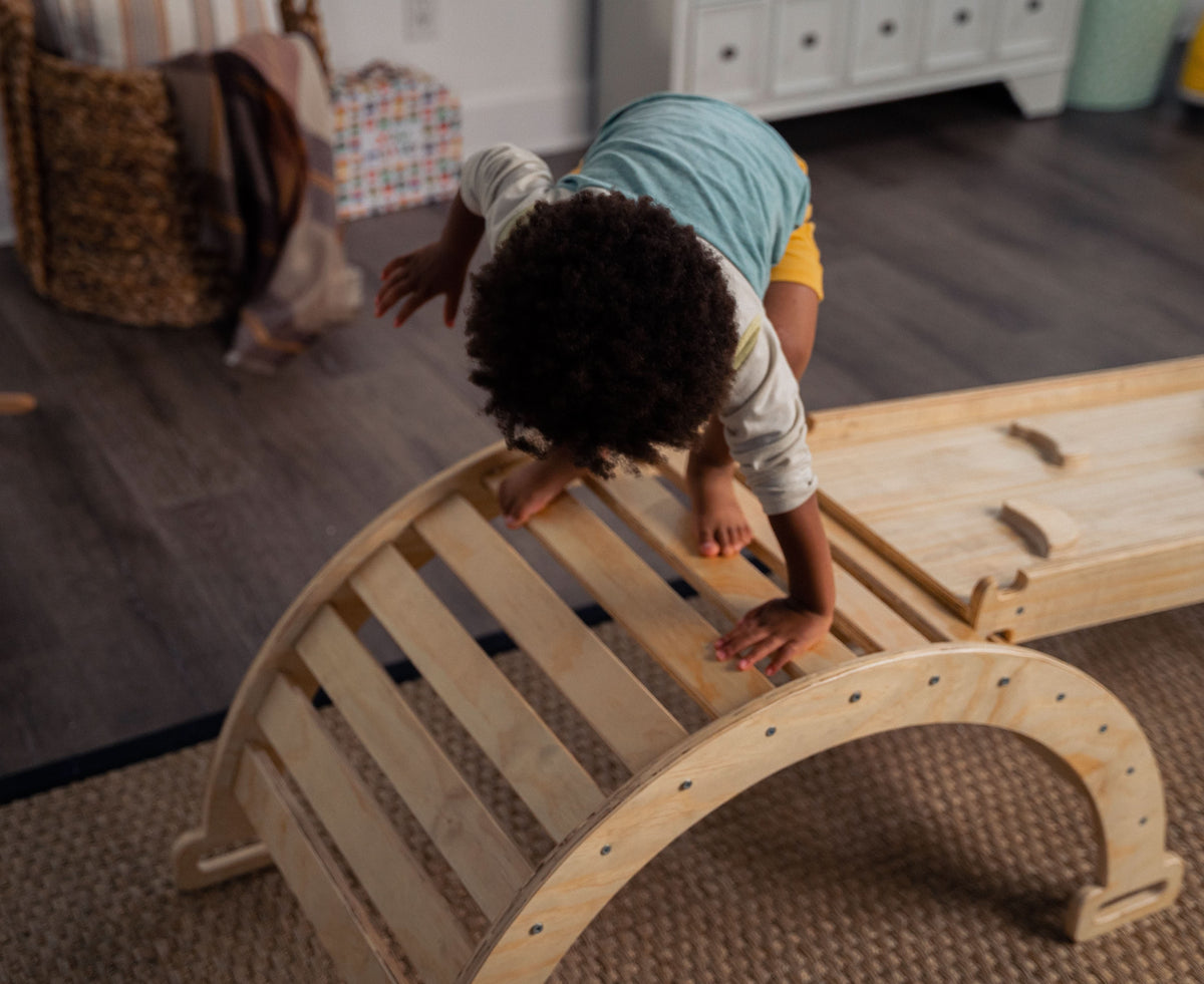 Toddler climbing up the Avenlur Hazel Pikler ramp