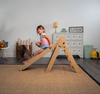 Toddler on the Avenlur Hazel climbing triangle at home