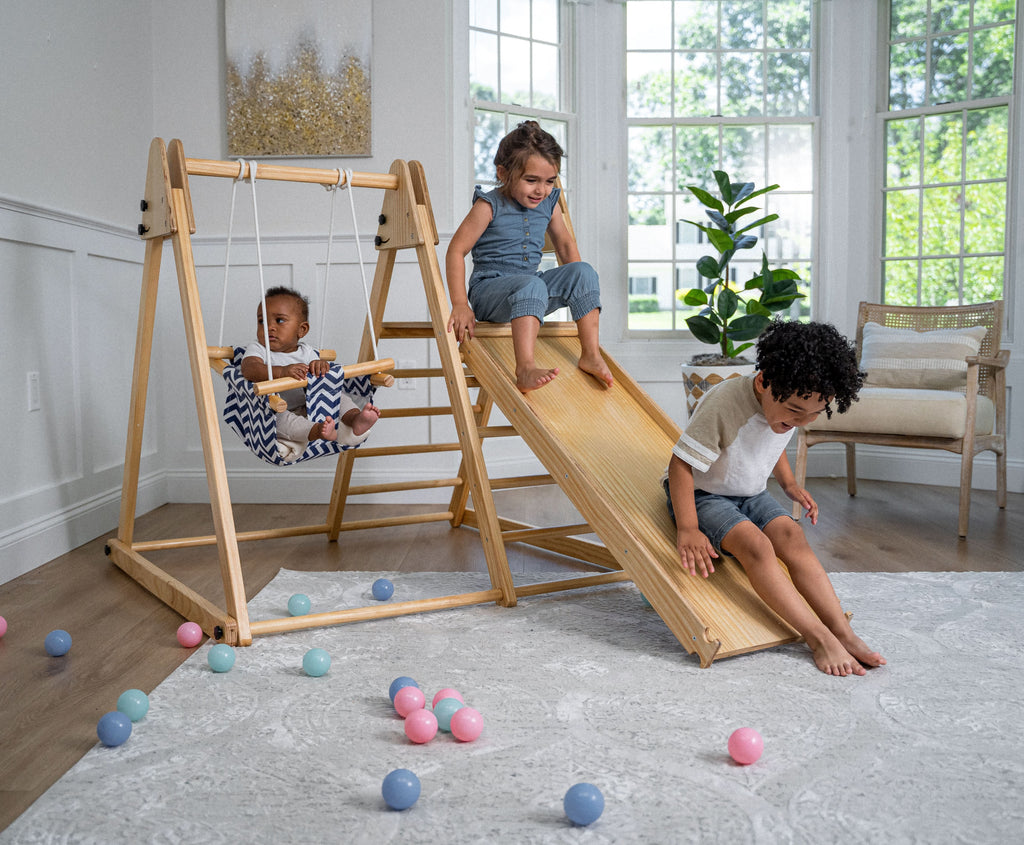 Toddler climbing the Avenlur Juniper indoor climber for toddlers