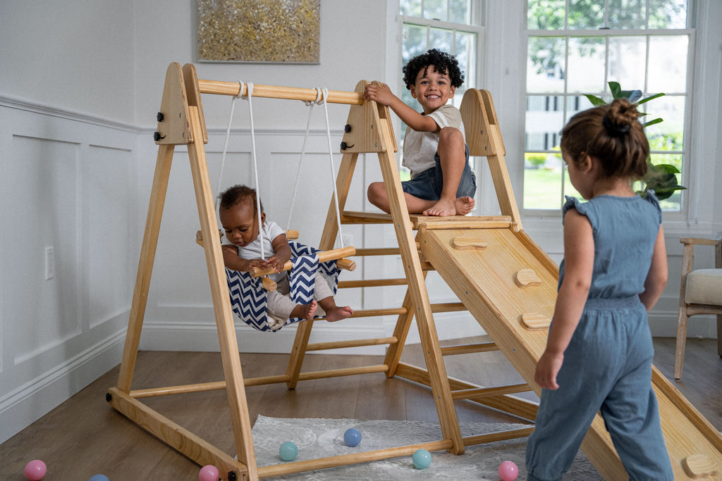 Toddler on the Avenlur Juniper toddler swing indoors