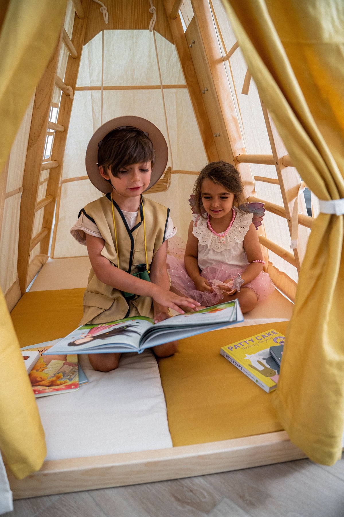 Child reading inside the Avenlur Magnolia tent hideaway