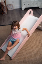 Toddler going down the Avenlur Manuka indoor slide for toddlers