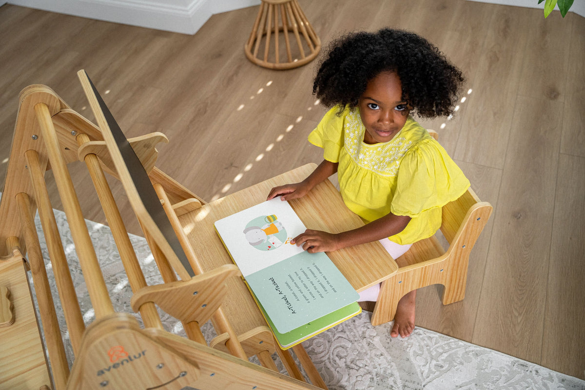 Toddler having a snack at the Avenlur Pikler desk