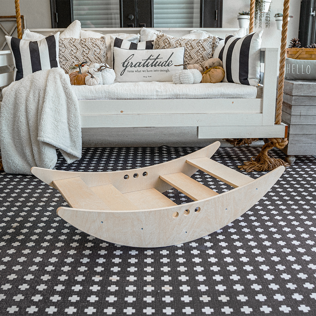Avenlur Rowan 2-in-1 wooden rocking boat shown in boat configuration with a natural finish