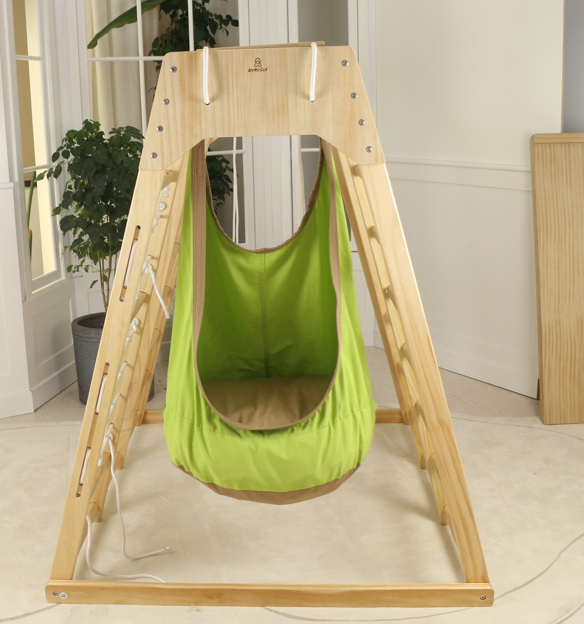 Avenlur sensory swing add-on hanging from a large indoor climber