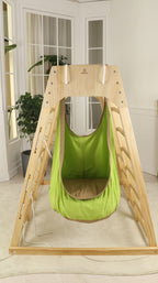 Child relaxing in the Avenlur sensory swing attached to a climber