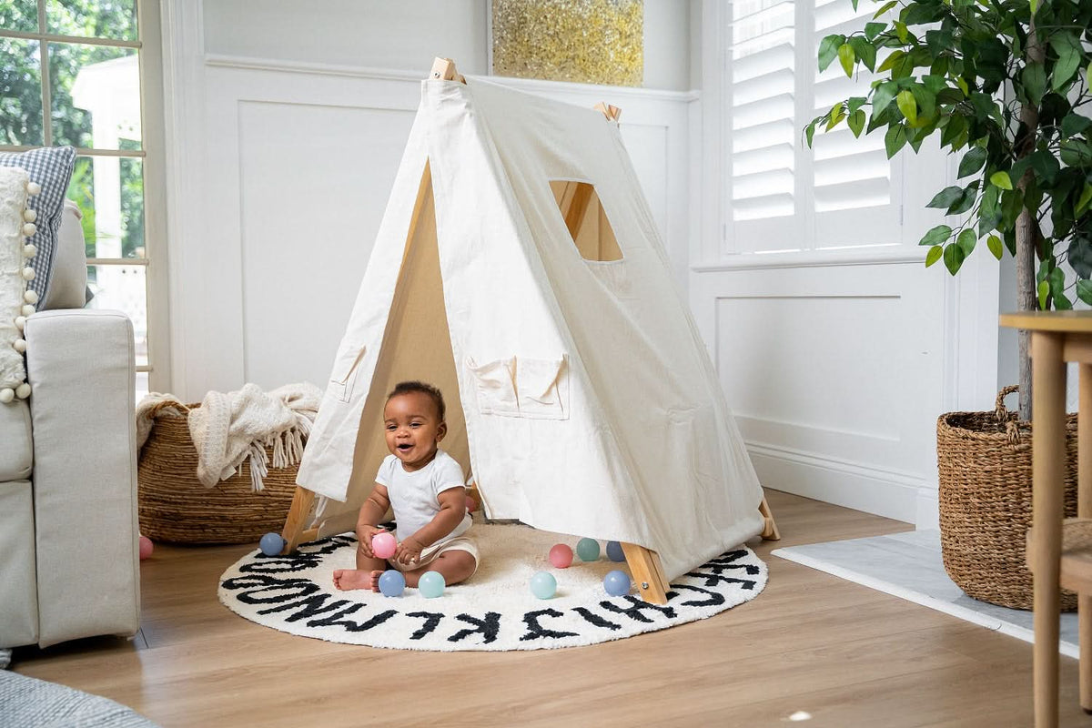 Baby playing inside the Avenlur canvas tent cover